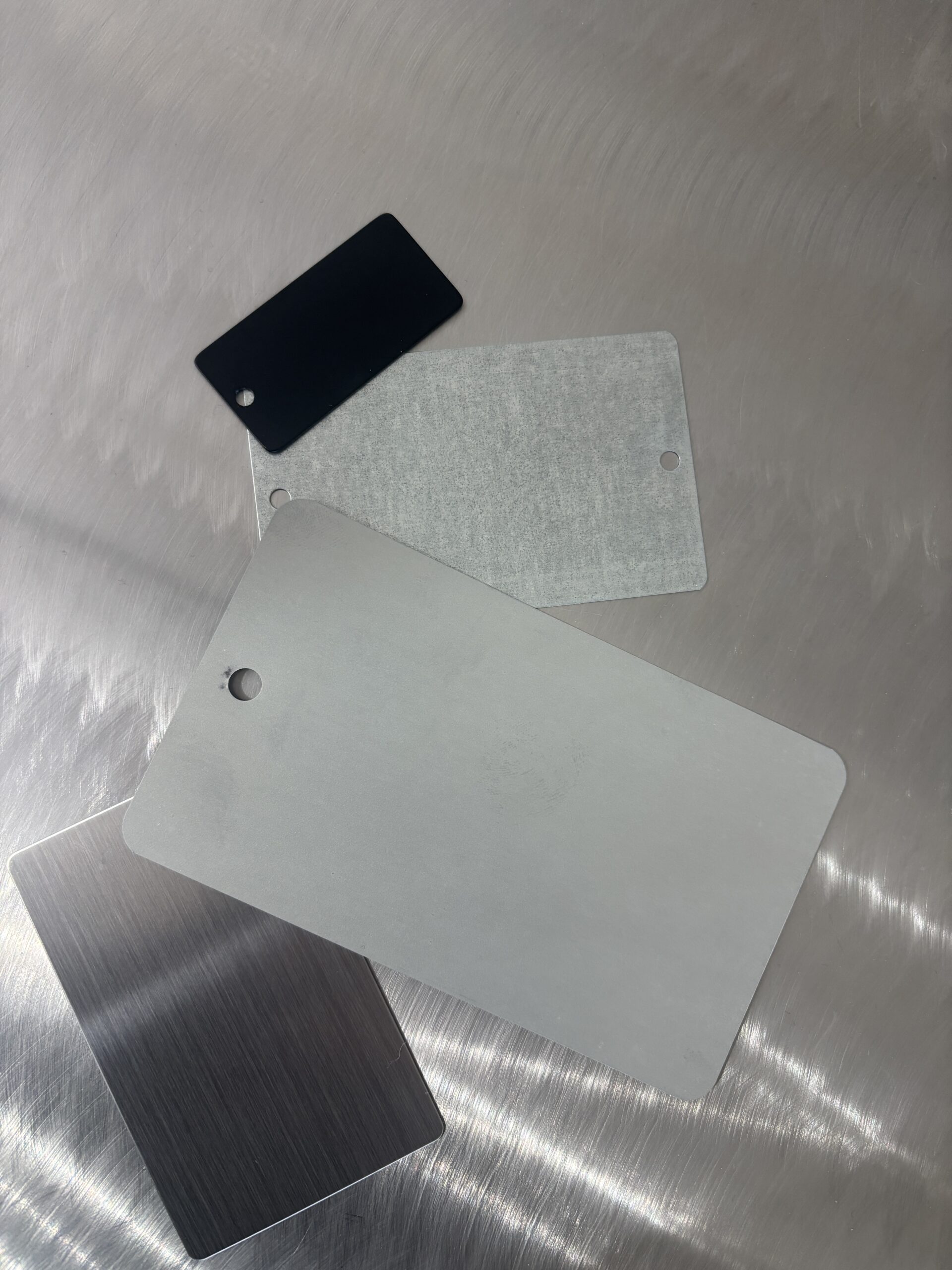 Various metal sample tags arranged flat